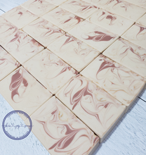 Load image into Gallery viewer, Cream, rose clay pink and gold swirled artisan soap bars.  Coconut Rose Soap Supreme is formulated of luxurious cocoa butter, organic coconut milk, and our botanical oil blend infused with cruelty-free silk, fragranced to perfection - it’s a little coconut-y, a little vanilla-y, IT. IS. STUNNING. The fragrance profile is a sweet and soft mix of coconut, candy apple, raspberry, red currant, tulip, freesia, heliotrope, rose, cashmere musk, vanilla, and amber. Skin Joy Soap Murfreesboro