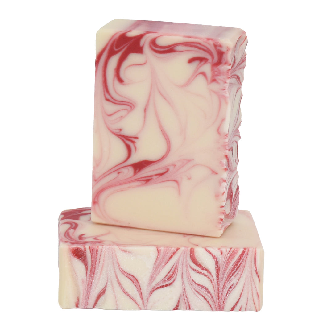 Red and white swirled artisan soap bars.  Handcrafted Natural Soap: Peppermint Bark is formulated of nourishing botanical oils and cocoa butter, infused with organic coconut milk and luxurious silk fibers.  We love mint year round but peppermint is the quintessential winter scent.  Skin Joy Soap Murfreesboro Tennessee 