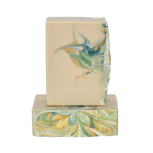 Cream with swirls of green, teal and gold bar soap. Handcrafted Natural Soap: Imagine a warm summer breeze, a tropical umbrella drink in hand, and sun kisses on your face – our Coconut Lime Verbena passes the vibe check!  Formulated of nourishing botanical oils and cocoa butter infused with organic coconut milk, kaolin clay, and luxurious silk.  Fine soap Murfreesboro, Tennessee