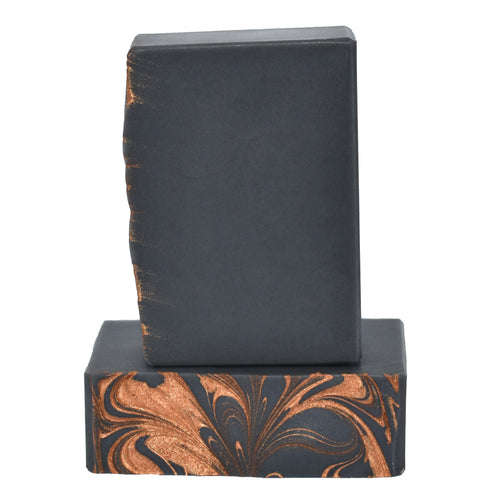 Dark gray and metalic copper swirled bar soap.  Copper + Steel is woody and masculine with top-notes of lemon, lime and a splash of orange, middle-notes of petitgrain, cardamom, rosemary, lily of the valley, jasmine and rose, and base-notes of amber, white musk, fir, vetiver, oakmoss and rosewood.  Natural soap Murfreesboro Tennessee