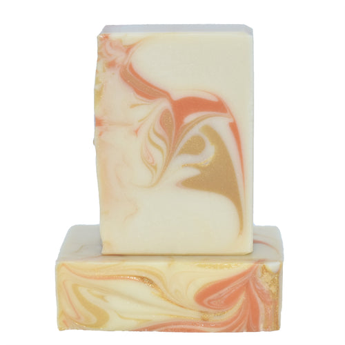 Creamy white with gold and orange swirled artisan soap. Handmade Natural Soap: Orange Patchouli Soap Supreme is a refreshing yet exotic essential oil fragrance oil blend of sweet orange and patchouli - even those who do not usually enjoy patchouli love this blend!  The sweetness of the orange tones down the woody-spice of the patchouli for a well rounded, elevated, almost effervescent fragrance.   Skin Joy Soap Murfreesboro Tennessee