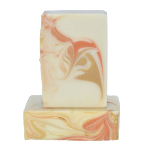 Creamy white with gold and orange swirled artisan soap. Handmade Natural Soap: Orange Patchouli Soap Supreme is a refreshing yet exotic essential oil fragrance oil blend of sweet orange and patchouli - even those who do not usually enjoy patchouli love this blend!  The sweetness of the orange tones down the woody-spice of the patchouli for a well rounded, elevated, almost effervescent fragrance.   Skin Joy Soap Murfreesboro Tennessee