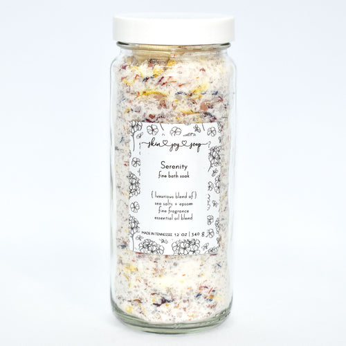 Luxurious bath salt soak with botanicals in glass jar. Serenity Bath Soak is a relaxing blend of sea salts and epsom salt.  The calming aroma is crafted of Bulgarian lavender and geranium essential oils blended with fine fragrance to elevate the bathing ritual...we really should have named this one Mellow Mood. 
