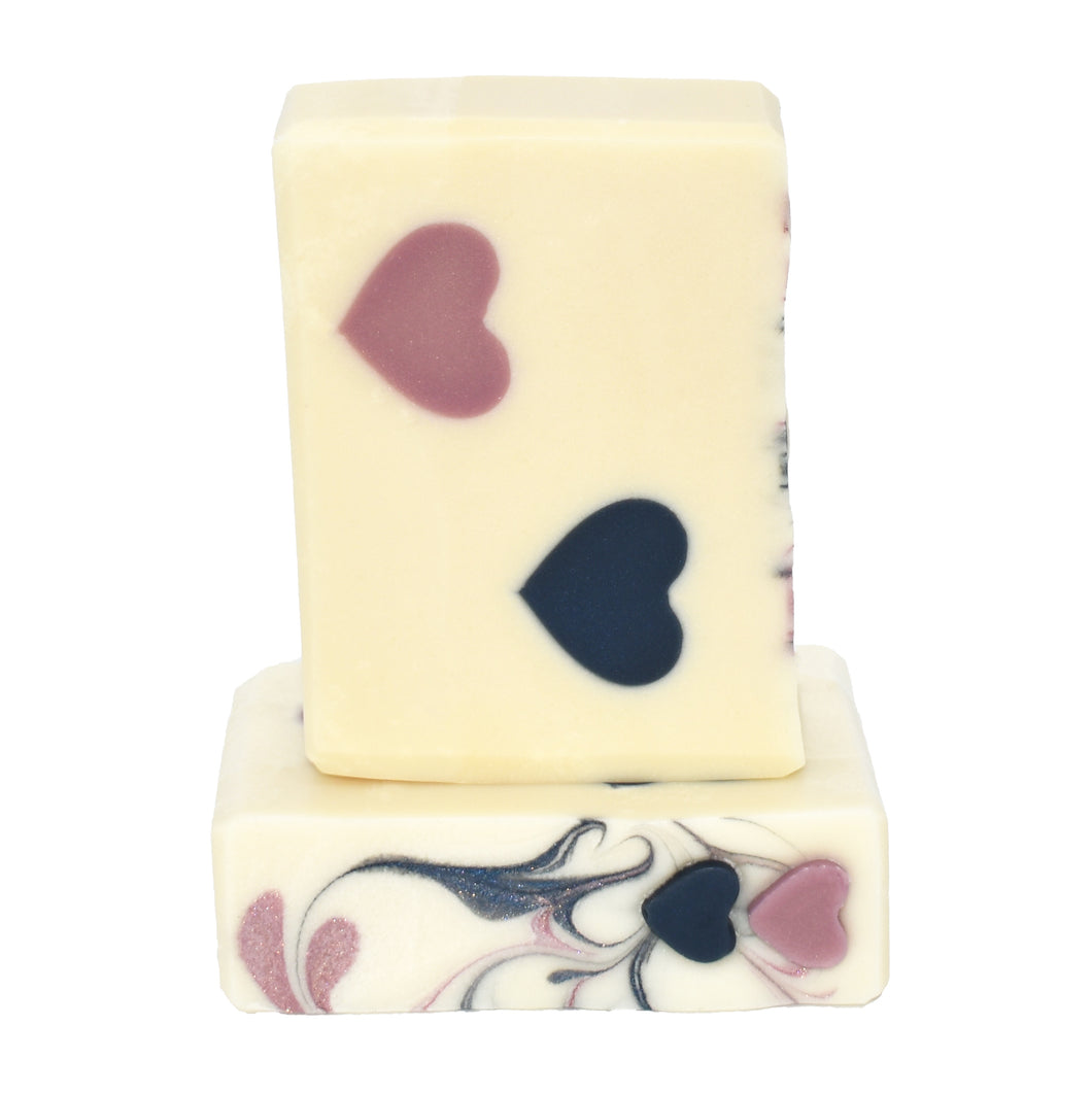 Ivory white artisan soap with navy and blush hearts. Handcrafted Luxury Natural Soap: Two Hearts is formulated of nourishing botanical oils infused with organic coconut milk and luxurious silk fibers.  The fragrance is a fresh citrus grapefruit with a hint of delicate floral ylang ylang.  Skin Joy Soap Murfreesboro Tennessee