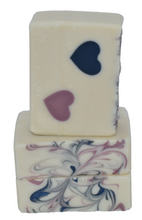 Load image into Gallery viewer, Ivory white artisan soap with navy and blush hearts. Handcrafted Luxury Natural Soap: Two Hearts is formulated of nourishing botanical oils infused with organic coconut milk and luxurious silk fibers.  The fragrance is a fresh citrus grapefruit with a hint of delicate floral ylang ylang.  Skin Joy Soap Murfreesboro Tennessee
